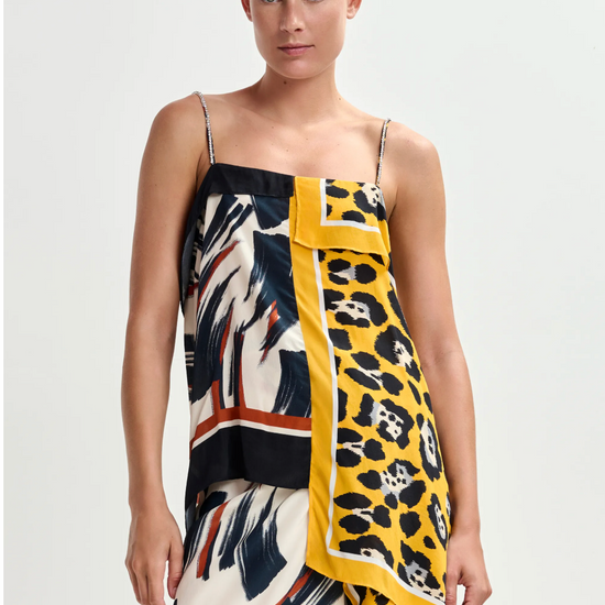 Woman wearing a colorful patterned dress with a white background