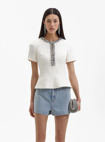 Ecru structured top with split crew neckline short sleeves and silver sequin and beaded detail about the neckline