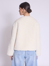 white faux fur cropped jacket with black buckle fastening and v neck  rear view 