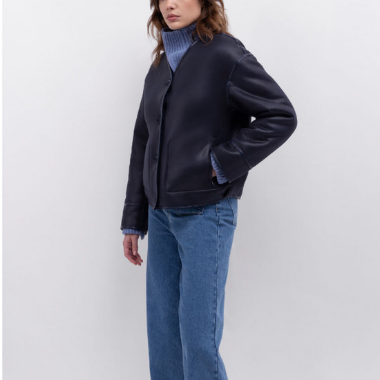 navy faux fur reversible round neck jacket with patch pockets, long sleeves, black buttons and interior dark navy faux suede with fur detailing model shot