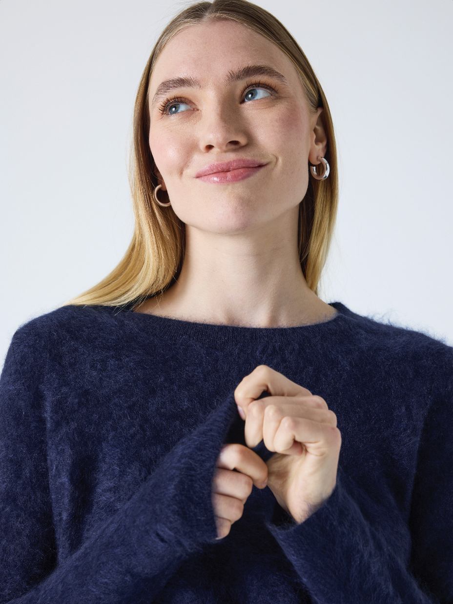 crew neck navy cashmere jumper with fluffy texture close up