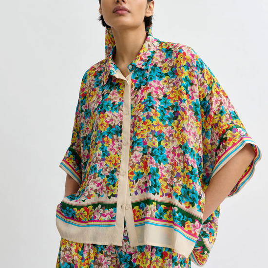 Floral blouse worn with matching trousers and head scarf