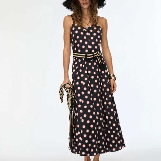 Model shot of women wearing black printed skirt with matching top and hat