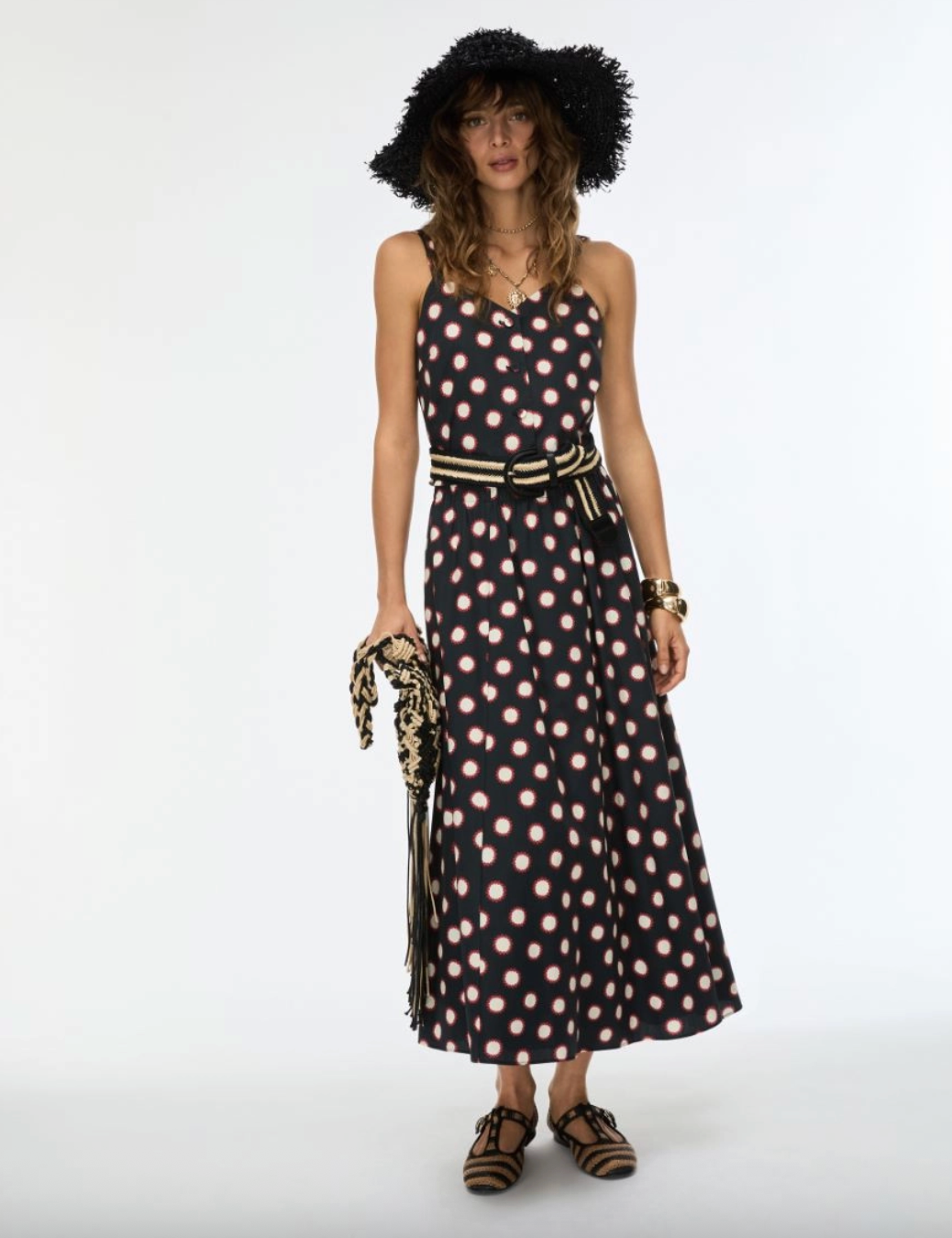 Model shot of women wearing black printed skirt with matching top and hat