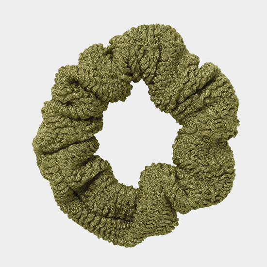 Green scrunchie on a light gray background