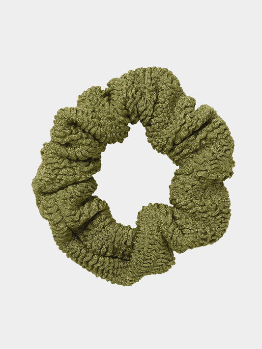 Green scrunchie on a light gray background