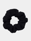 Black scrunchie on a light gray background