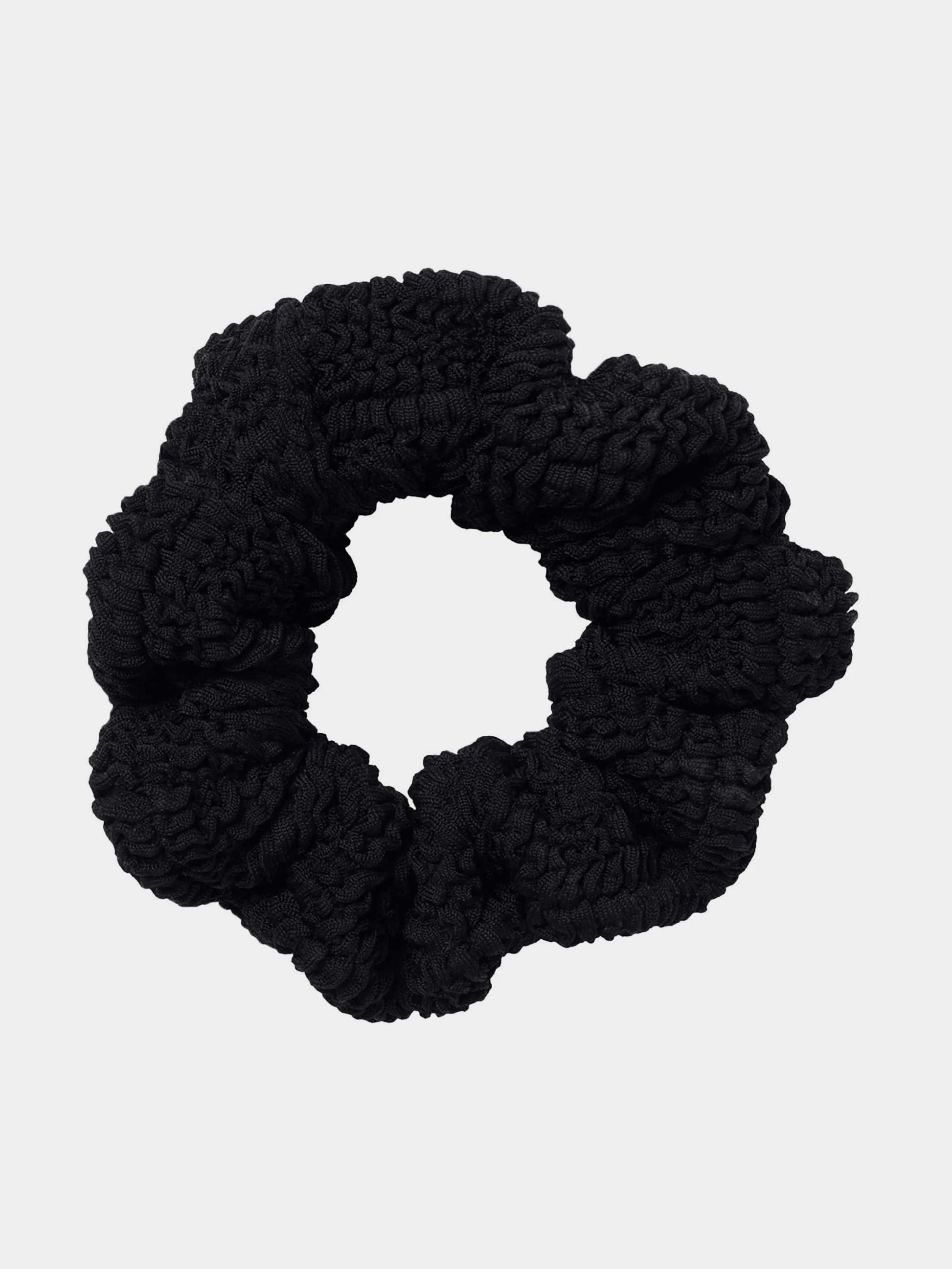Black scrunchie on a light gray background