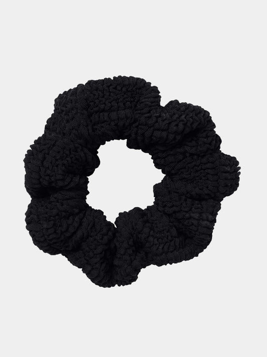Black scrunchie on a light gray background