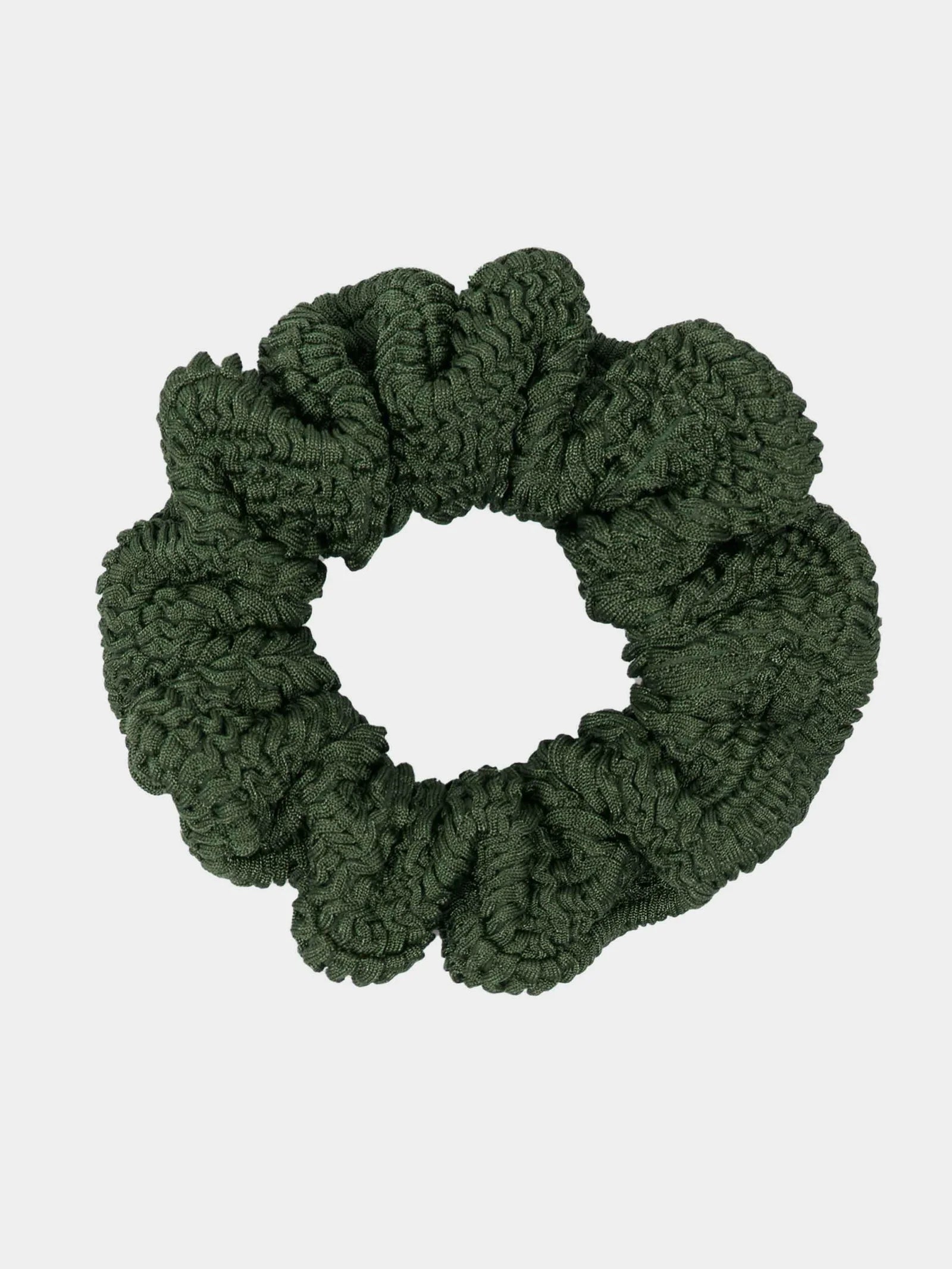 Green scrunchie on a light gray background