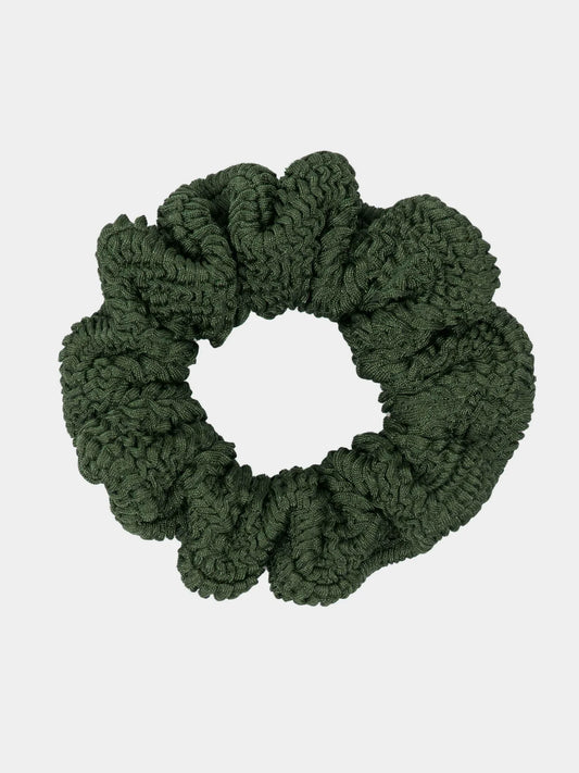 Green scrunchie on a light gray background