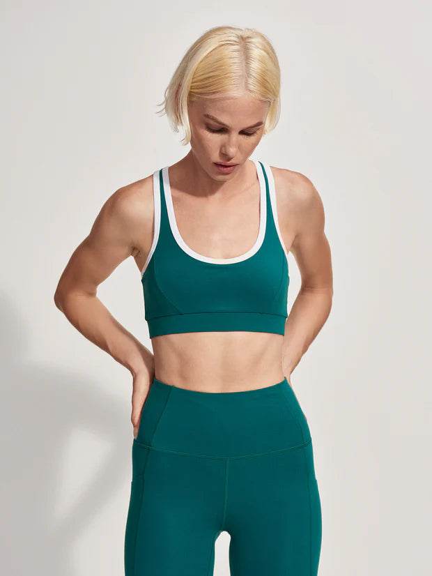 green sports bra with racerback and white trim