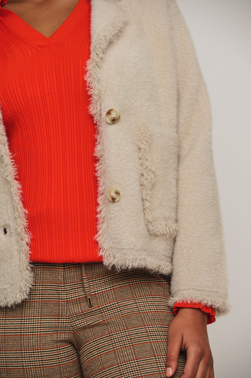 beige single breasted furry jacket close up