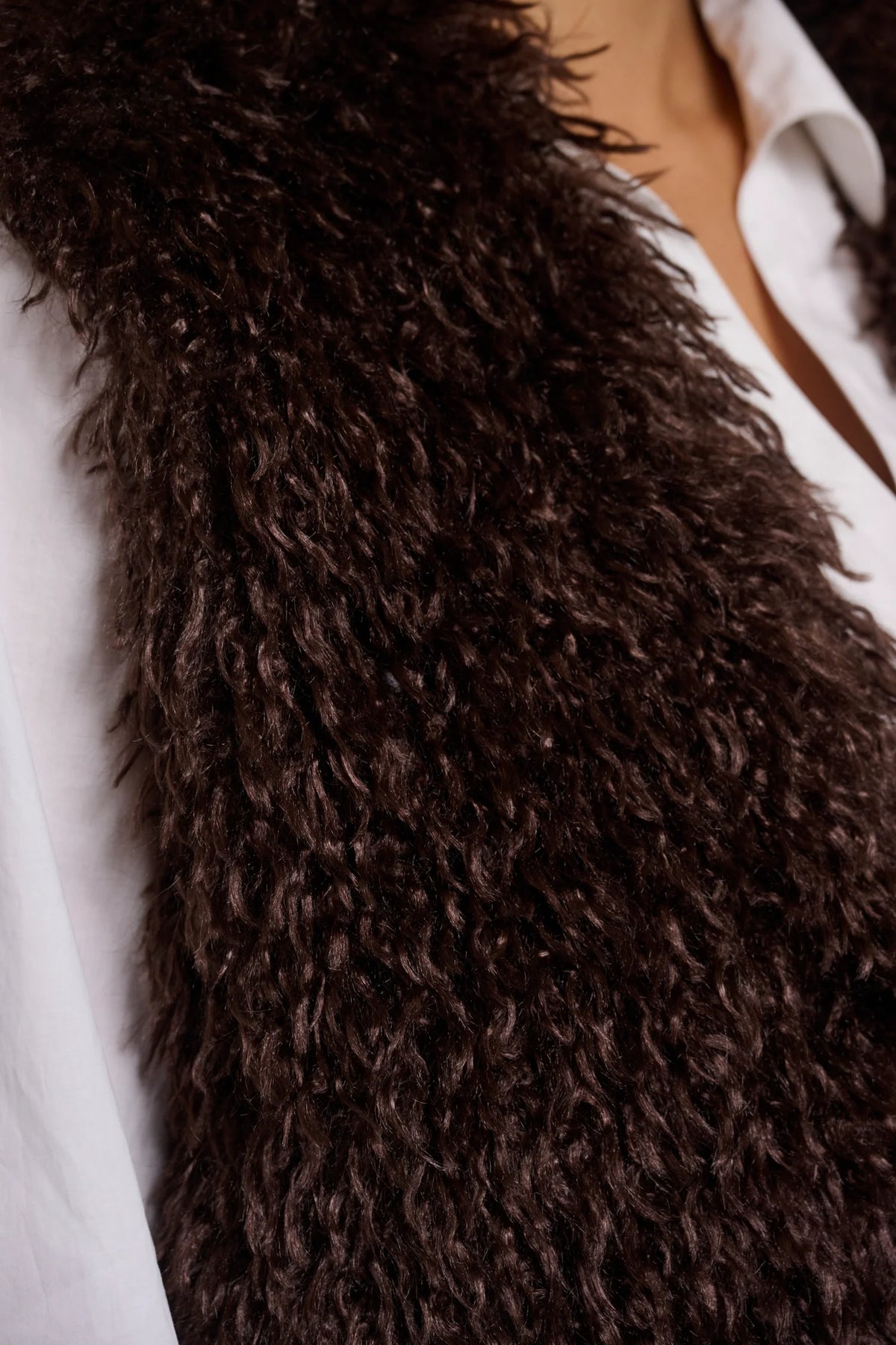 Close-up of a brown fluffy scarf on a white background