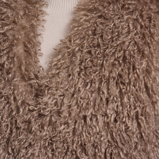 Close-up of a brown fluffy garment with a blurred background