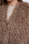 Close-up of a brown fluffy garment with a blurred background