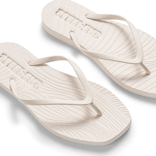 white flipflop on white background another angle