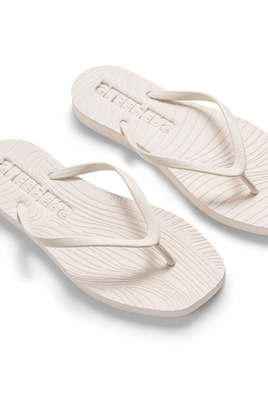 white flipflop on white background another angle