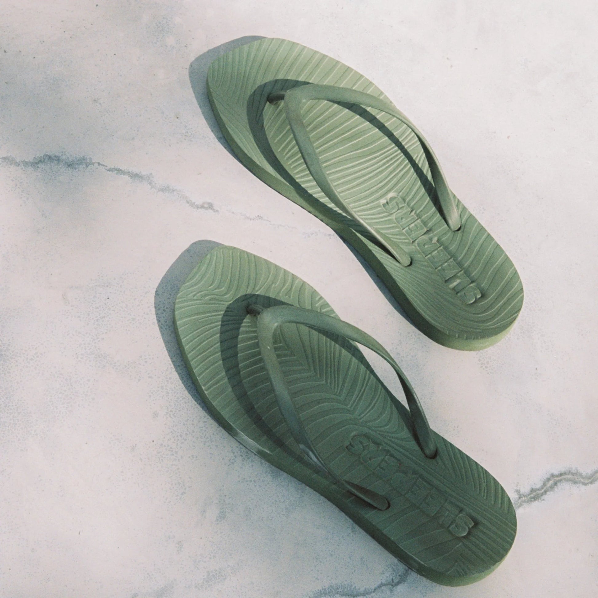 Square toe green rubber flip flops from sleepers