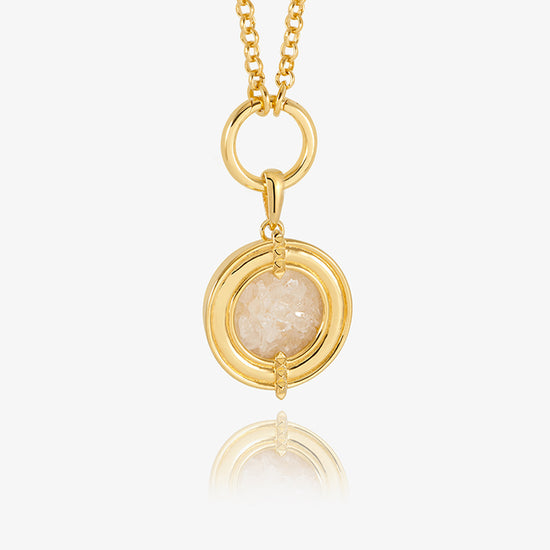 gold statement necklace with circle and pendant with crystals inside model shot close up