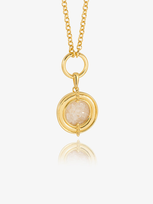 gold statement necklace with circle and pendant with crystals inside model shot close up