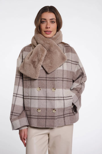 Woman wearing a plaid coat with a fur collar on a white background