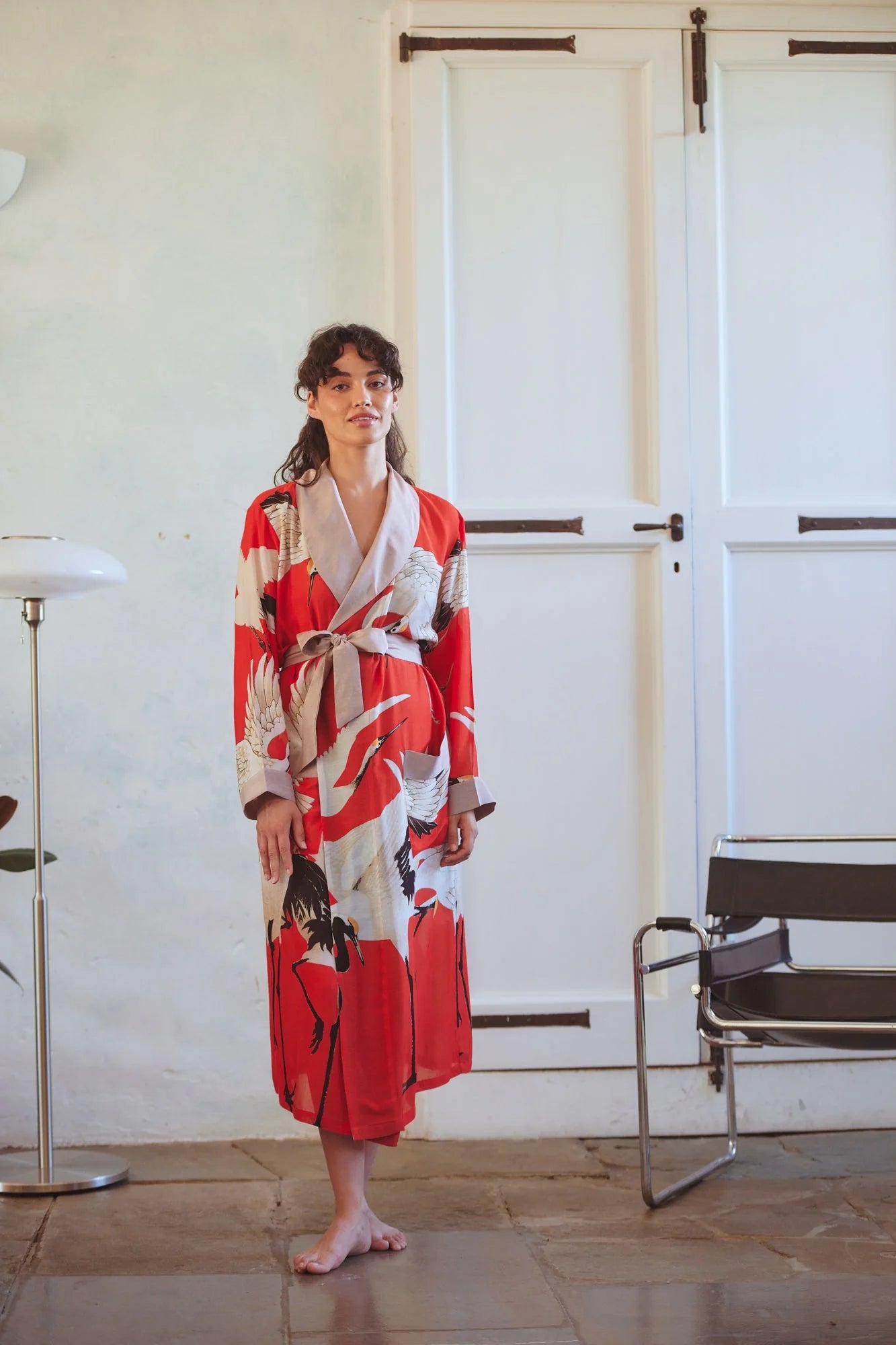 Women wearing red stork gown from 100 stars
