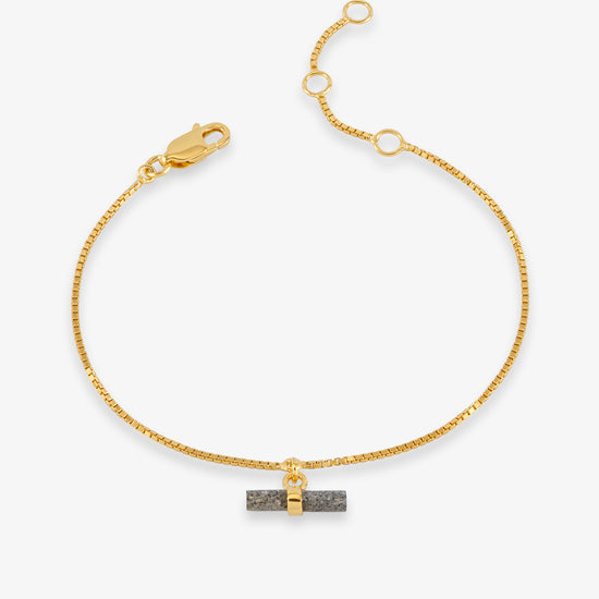 gold bracelet with grey stone t bar on white background