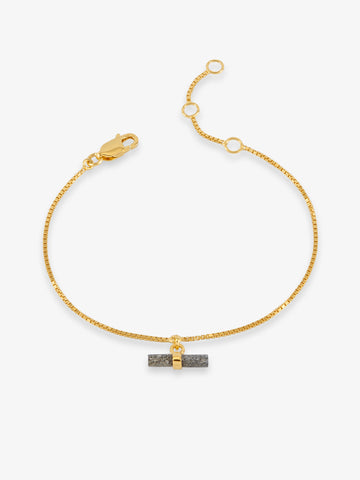 gold bracelet with grey stone t bar on white background