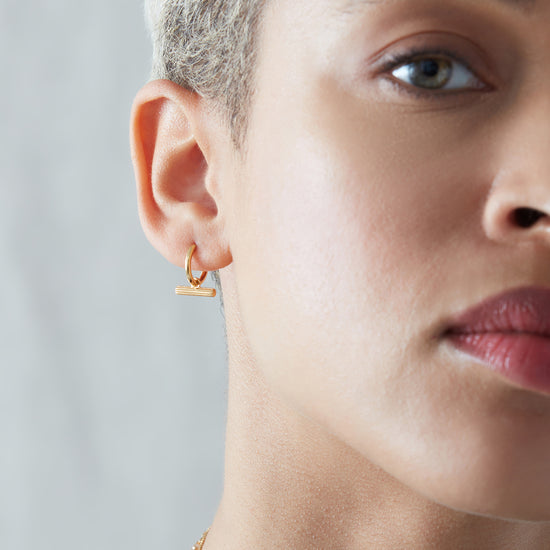 mini t bar huggie earrings gold from rachel jackson model shot