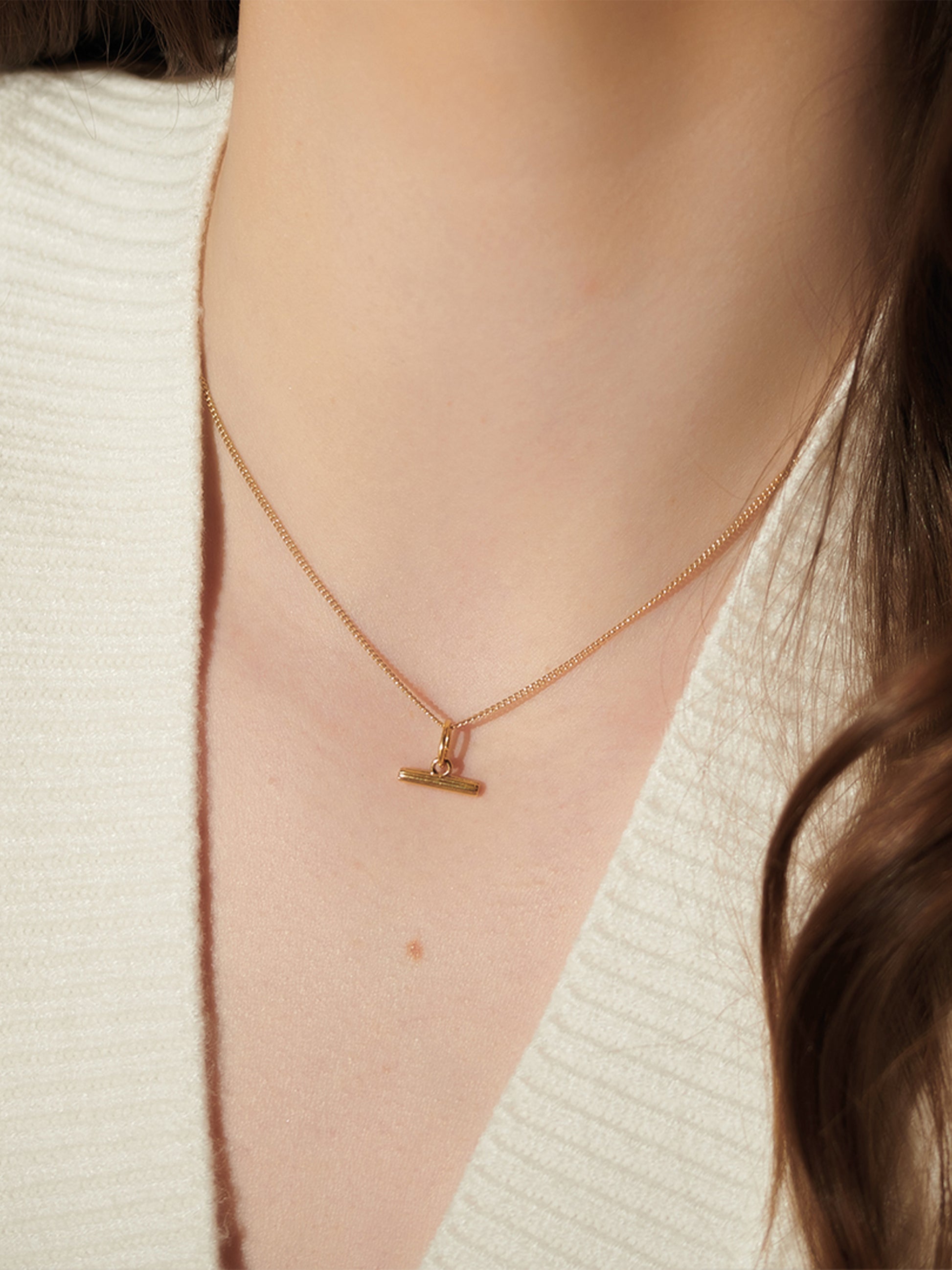 gold t-bar mini necklace on a delicate gold chain from rachel jackson model shot