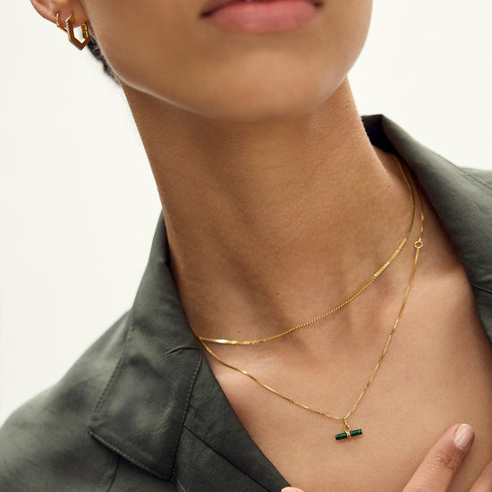 malachite rectangular pendant on a delicate gold chain and a gold ring from rachel jackson model shot
