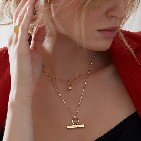 gold t bar necklace with a circular ring and a delicate gold chain from rachel jackson model shot