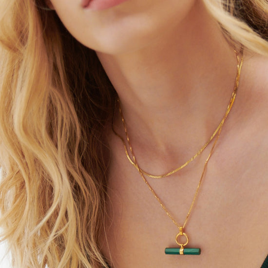 malachite stone rectangular necklace with gold ring and a delicate gold chain from rachel jackson model shot