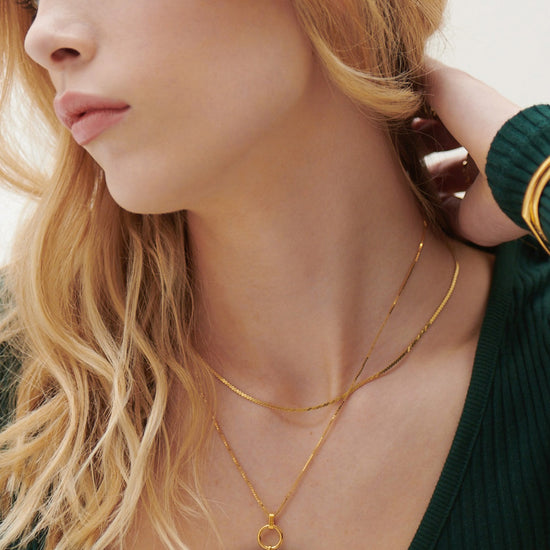 malachite stone rectangular necklace with gold ring and a delicate gold chain from rachel jackson model shot