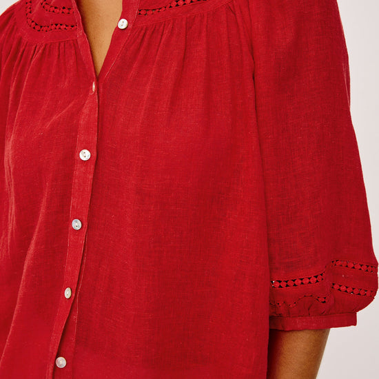 Red blouse with button details on a white background