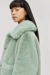 Soft green short boxy faux fur jacket with large collar and two front patch pockets