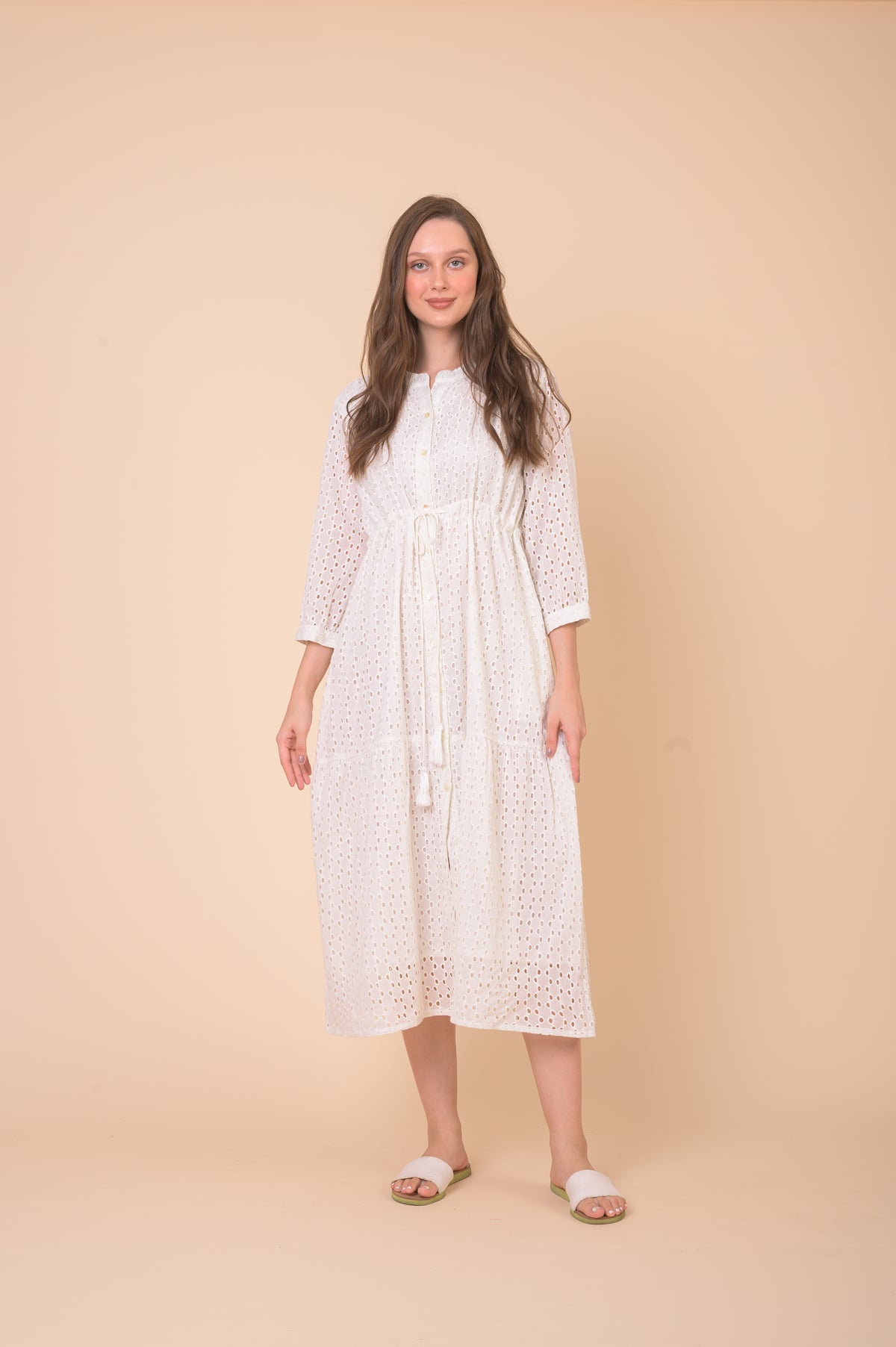 White midi dress with three quarter length sleeves and drawstring waist in eyelet fabric