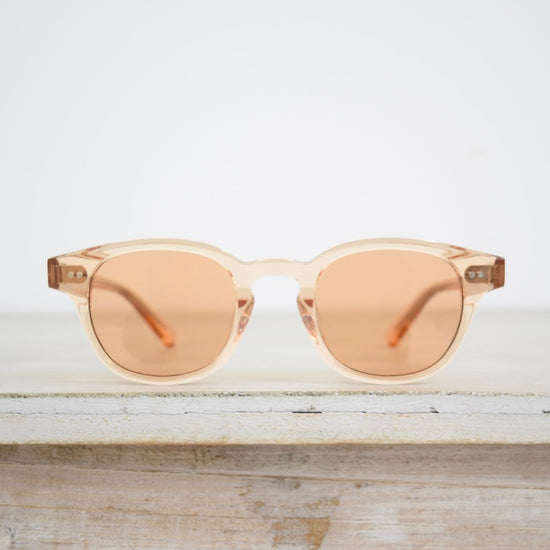 small round sunglasses with a pink tint