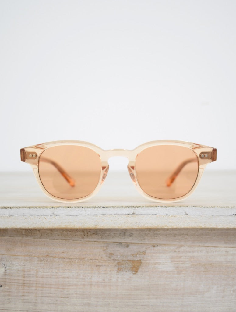 small round sunglasses with a pink tint