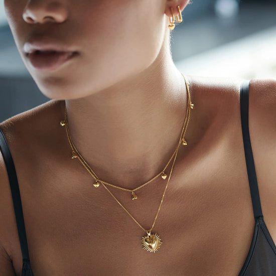 gold necklace with gold heart charms from rachel jackson model shot