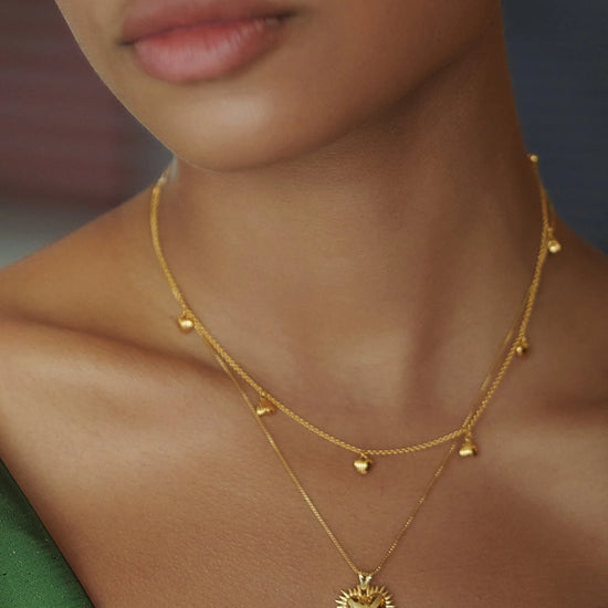 gold necklace with gold heart charms from rachel jackson model shot