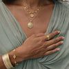 scalloped edge ring worn with matching necklace and stacked cuffs from Anna beck