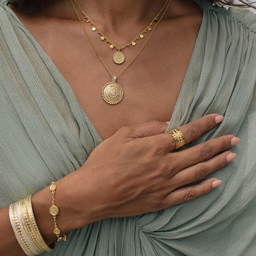 scalloped edge ring worn with matching necklace and stacked cuffs from Anna beck