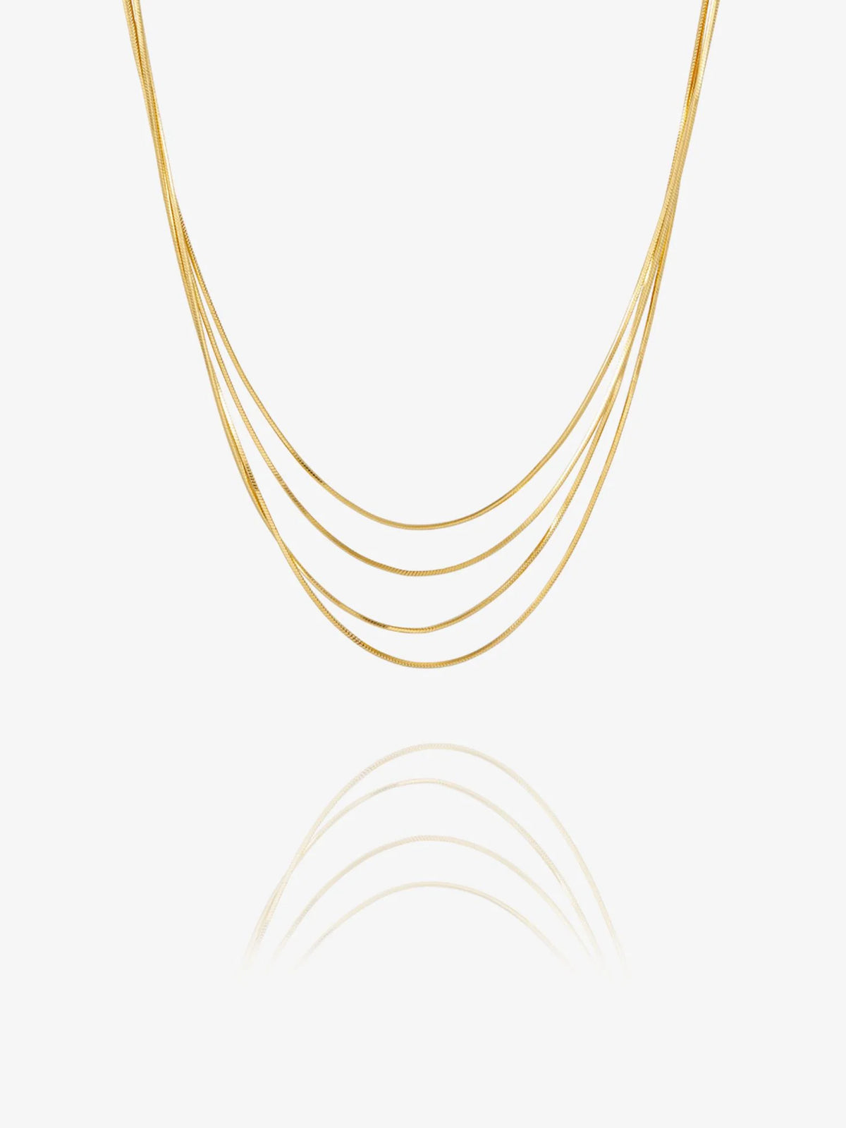A delicate multi-strand gold chain necklace with five parallel strands, displayed against a clean white background with a soft reflection below.