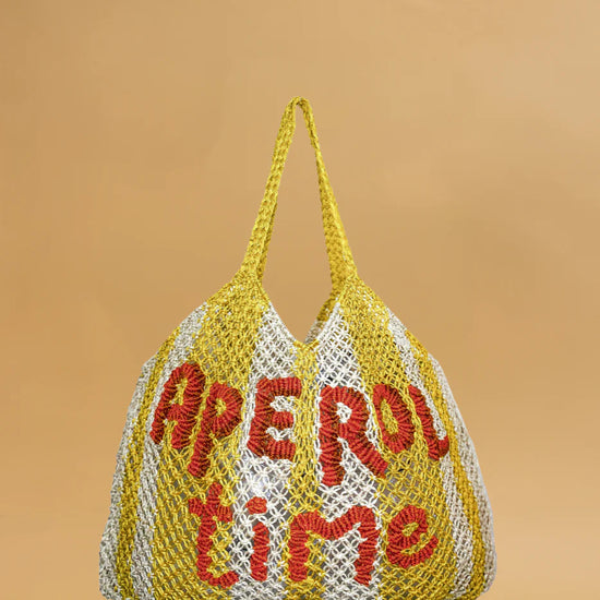 yellow and white string bag on yellow background