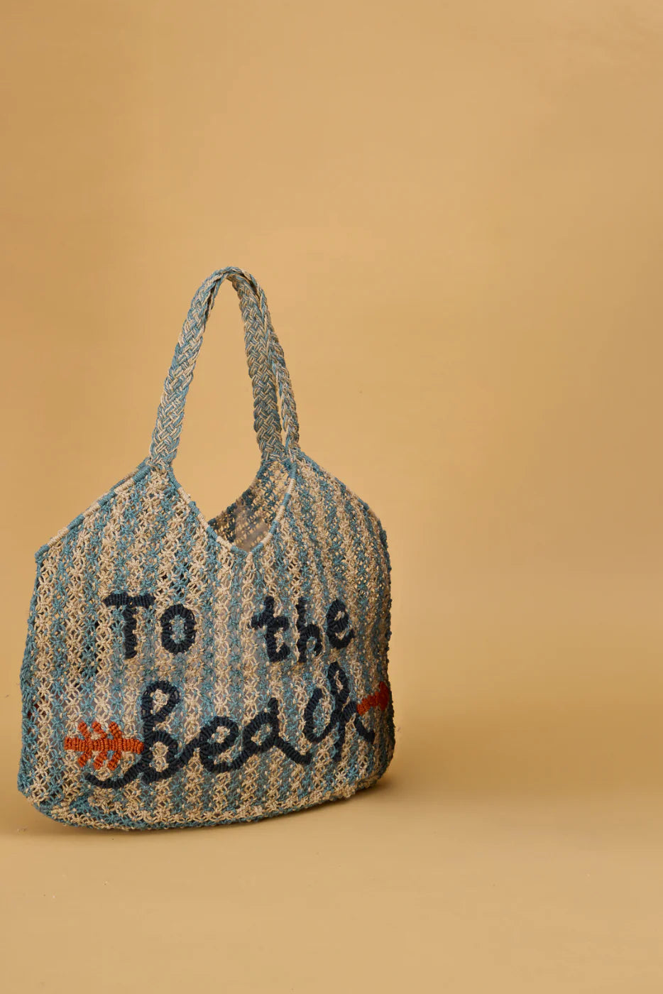 blue and beige string bag on yellow background