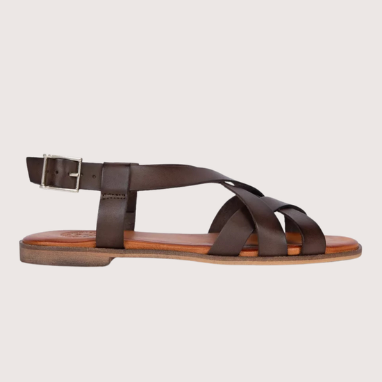 Brown sandal with a strap design on a light gray background