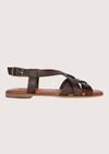 Brown sandal with a strap design on a light gray background