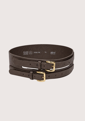 Two dark brown textured leather belts with gold-tone buckles, stacked and photographed on a light cream background. The brand name 'abro' is visible on the inside of the belt strap.